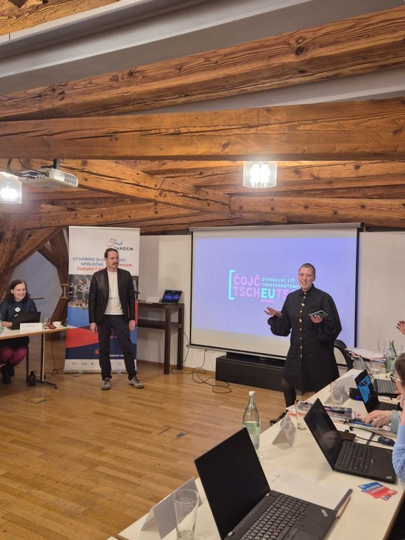 Mitglieder des Vereins Čojč halten eine Präsentation über ihre Arbeit.